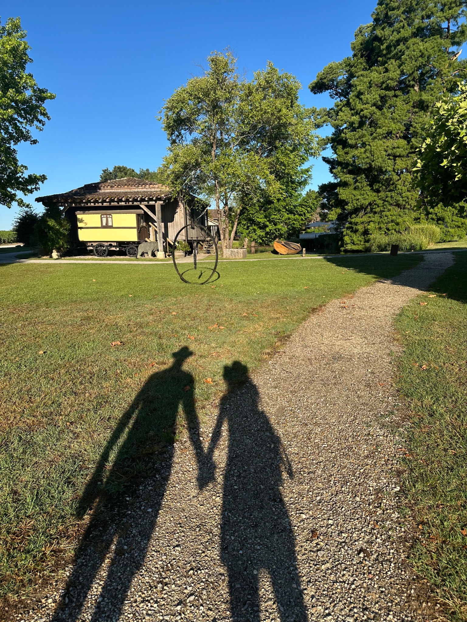 Two human shadows meeting along a path in France